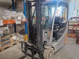 a forklift in a warehouse with pallets and boxes