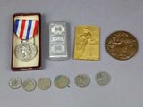 a small box with coins and a medal on it