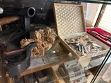 a display case with silverware and other items in it