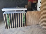 an image of a kitchen with a counter and a wooden wall