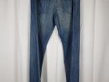 a close up of a pair of jeans hanging on a hanger
