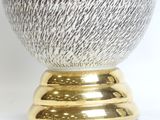 a silver and gold bowl sitting on a gold pedestal