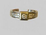 a close up of a gold and diamond ring on a white background