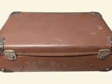 a brown suitcase sitting on top of a white surface