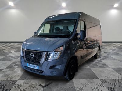 une camionnette bleue garée sur un sol en damier