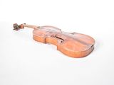 an old violin sitting on a white surface with a white background