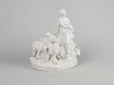 white porcelain figurine of a woman with sheep and lambs