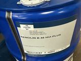 a blue and white drum sitting on the floor next to a blue wall