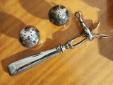 a silver spoon and two salt shakers on a table