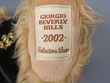 a teddy bear with a label on it that says georgia beverly hills 2002