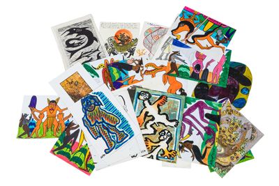 a pile of assorted art cards on a white surface