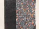 an image of a book with a black cover and a red and orange design