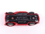 a red and black toy car on a white surface
