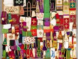 many different colored pieces of cloth hanging on a wall