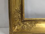 an image of a gold picture frame on a white surface