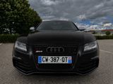 a black audi car parked in a parking lot