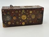 an old suitcase with a lot of buttons on it