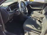 the interior of a car with the door open and the steering wheel down