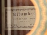 close up of a label on an acoustic guitar with a reflection of the strings