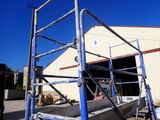 a blue scaffolding on the ground in front of a building