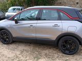 a silver car parked in a parking lot with other cars in the background
