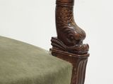 a chair that has a green cushion on top of it