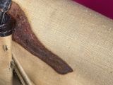 a close up of a purse with a brown handle