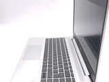 a white laptop with a black keyboard on a white surface
