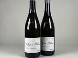 two bottles of wine sitting next to each other on a table