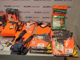 a table with a lot of orange life jackets on it
