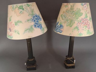 pair of lamps with floral lampshads on them on a gray surface
