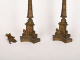 pair of antique bronze candlesticks with figures on them