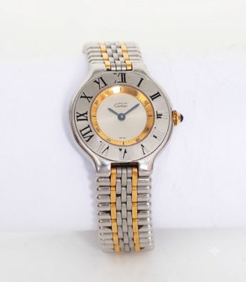 a close up of a watch on a white surface with a white background