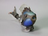 a small toy fish that is sitting on a table