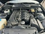 a car engine with its hood open on the street