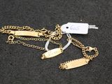 a close up of a gold chain with a tag on it