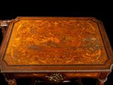 a small table with a wooden top with a design on it