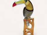 a bird that is sitting on top of a wooden block