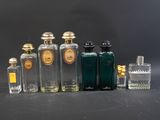 Plusieurs flacons de parfum sont alignés sur une table
