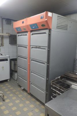 a kitchen with many drawers and a stove in it