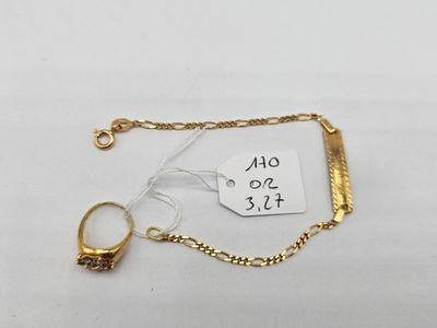 a close up of a gold chain bracelet with a ring on it