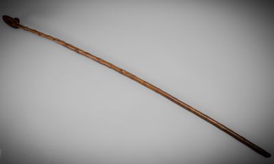 an old wooden stick with a long handle on a white surface