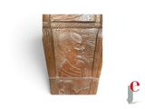 a wooden box with a carving of a man on it