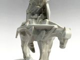 statue of a man riding a horse with a hat on top of it