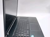 a black laptop computer sitting on top of a white table
