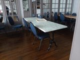 a table and chairs in a room with a mirror on the wall