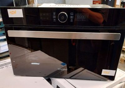 a microwave oven sitting on top of a stack of boxes
