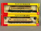 two boxed trains are sitting side by side on a table