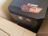 a hand that is holding a box with a computer inside of it