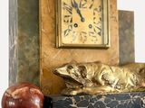 une horloge et une pomme posées sur la cheminée